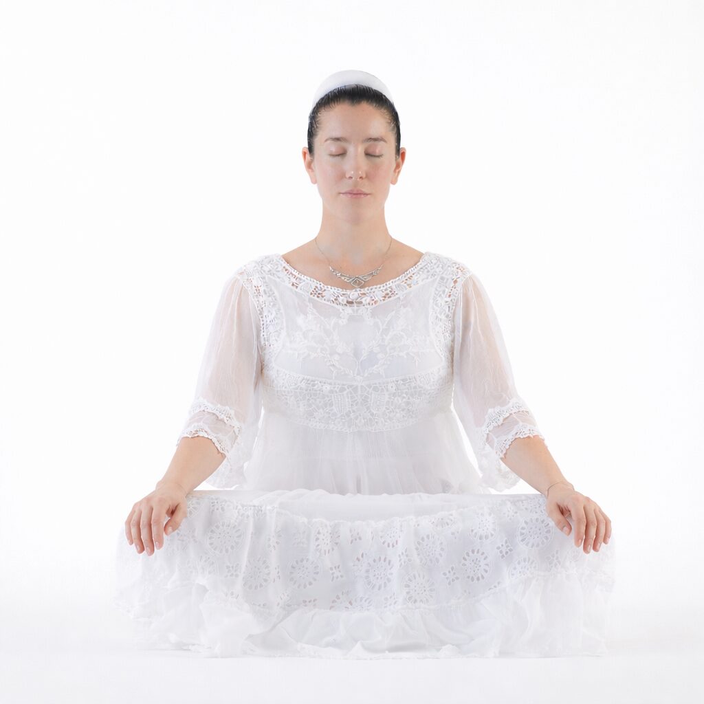 Woman practicing 8 Stroke Breath meditation in Gian Mudra to restore prana and release stress