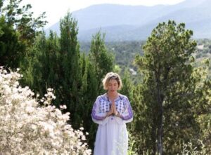 Woman in mountains in prayer pose